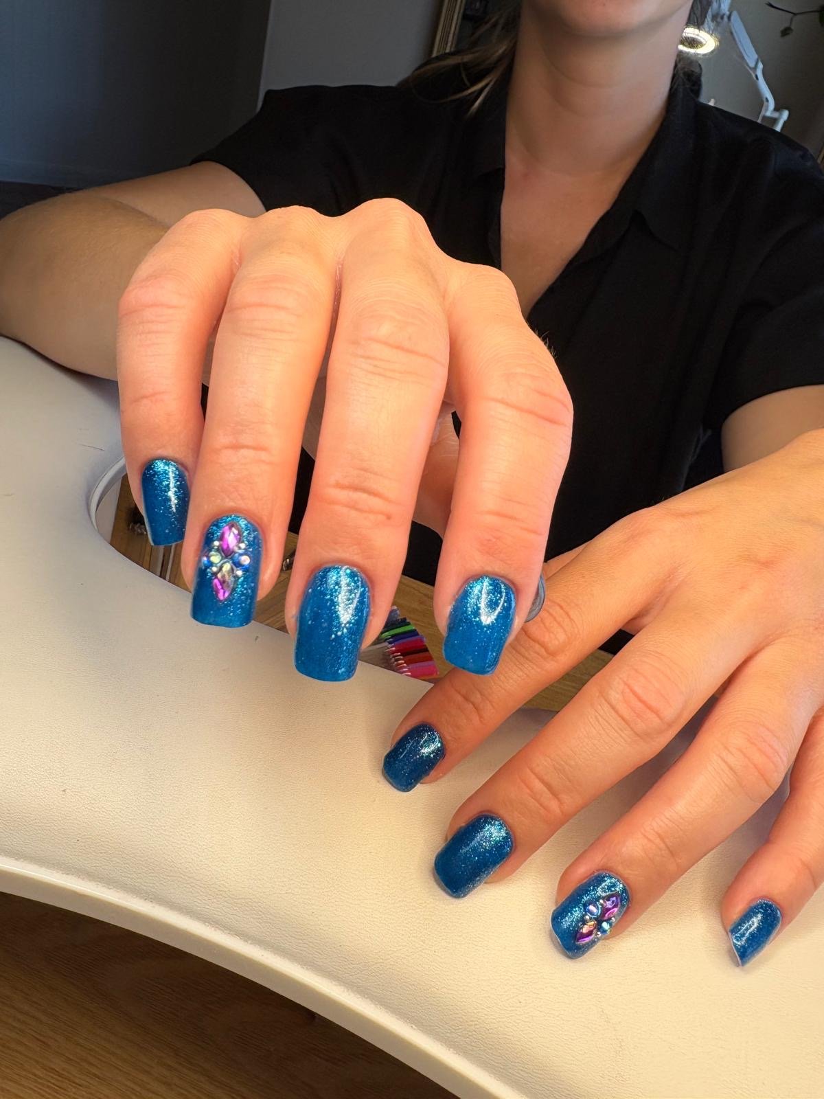 Russian manicure BIAB and colour in blue with glitter and gemstones at Queen Bee Nails in Rockingham WA