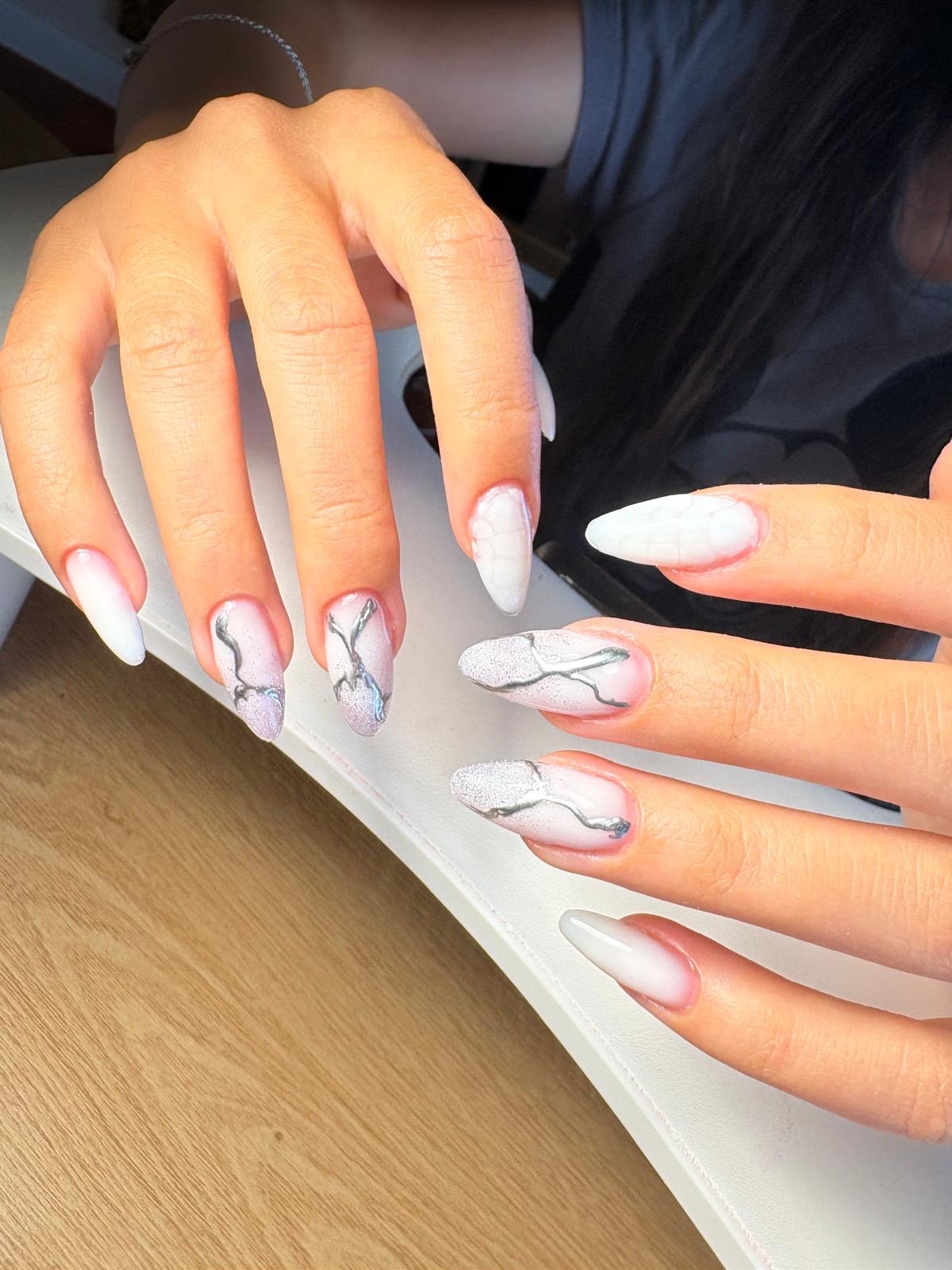 Russian manicure hard gel and colour in blooming white marble stiletto nail extensions with silver glitter detailing by Queen Bee Nails in Rockingham WA